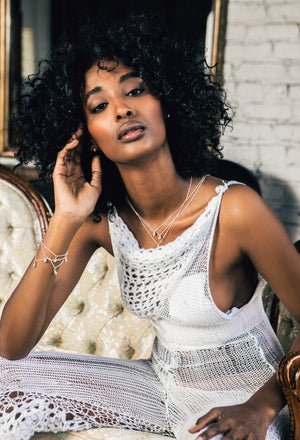 Maryam Jama Wearing Peggy Skemp Jewelry shell necklaces, earrings and multi shell necklace (as a bracelet) in solid recycled 925 silver. Photo by Kirsten Miccoli, hmua by Kerre Berry, Jumper by Entering the Fantastic, Styled by Jamie Vear of Gum no Sugar.