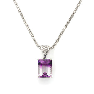 bicolor amethyst gemstone, half purple half white, very large step-cut, emerald cut collectable gemstone in a custom honeycomb setting.