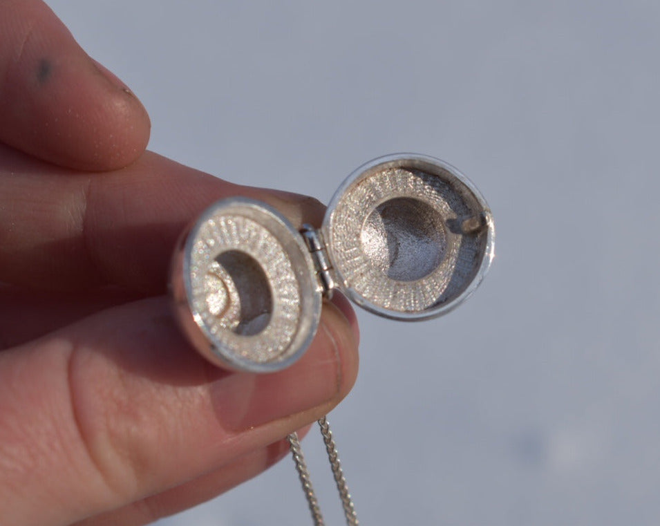 Anatomical eyeball locket in silver with black star sapphire pupil