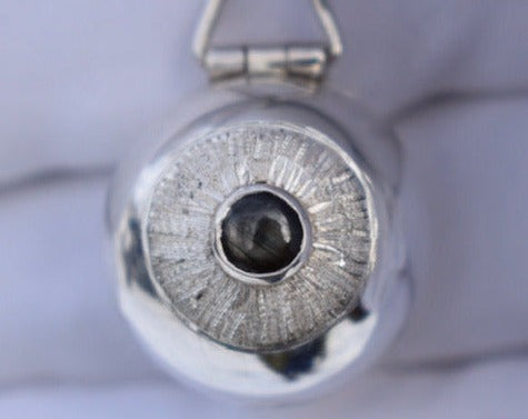 Anatomical eyeball locket in silver with black star sapphire pupil