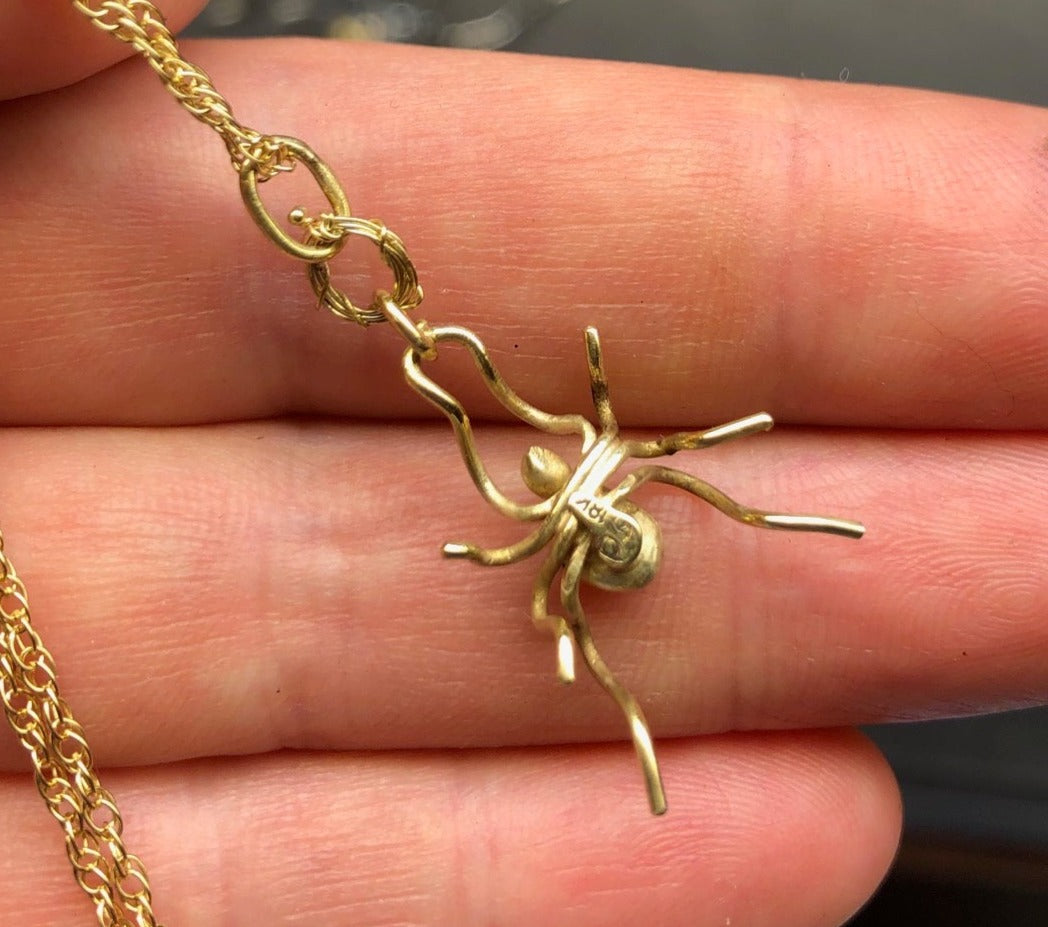 18ky gold spider with 2mm ruby and 18ky spun gold web