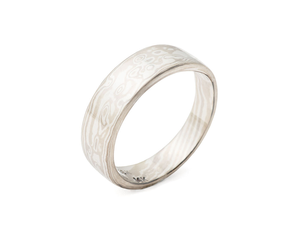 mokume gane ring in 14k and 18k palladium white gold and silver, heavy, tapered band with a combination wood-grain and fish-eye pattern, ring size 9.
