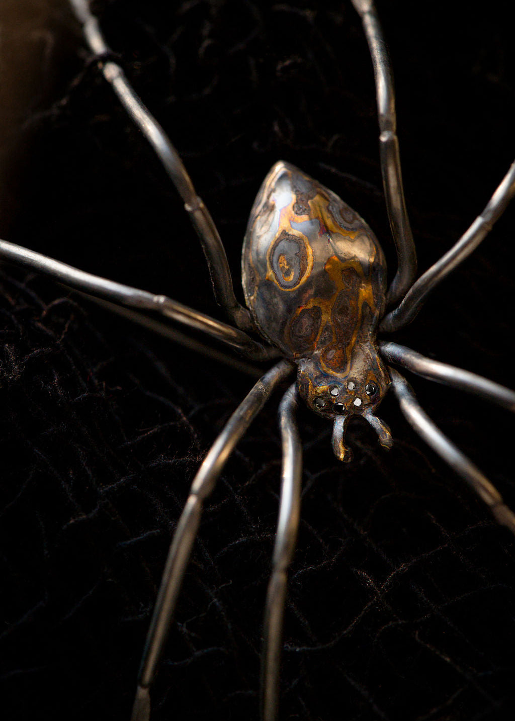 Silver, copper and green gold spider brooch with 6 black diamond eyes by Peggy Skemp