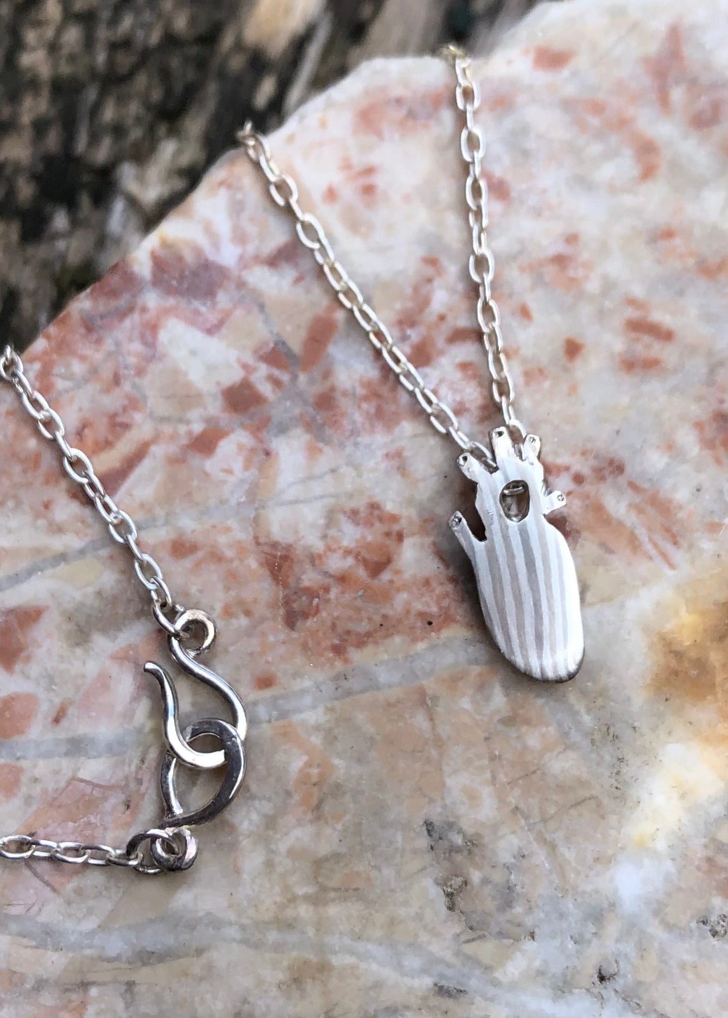mokume gane 14k, 19k palladium white gold and silver anatomical heart necklace.