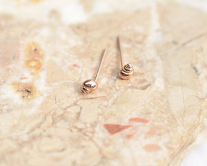 rose gold stud earrings- handmade 14k rose gold marine snail shell studs, handmade by Peggy Skemp 2021.