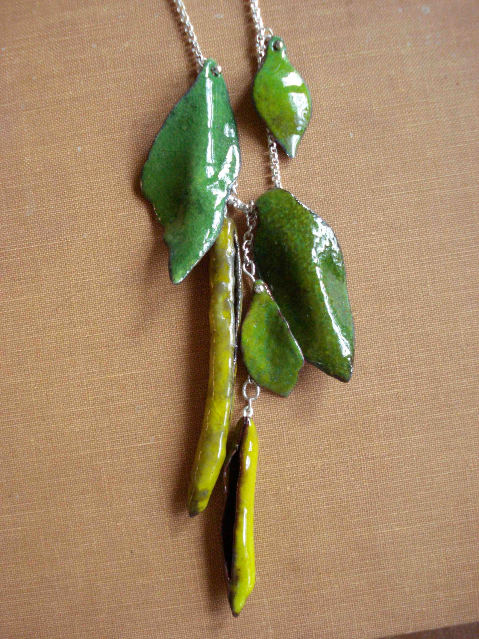hot glass enamelled one of a kind pea pod and leaf necklace, silver, copper and vitreous enamel by Peggy Skemp 2009.