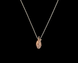 Tiny anatomical heart necklace in carnation pink silver with polished silver chain by Peggy Skemp.