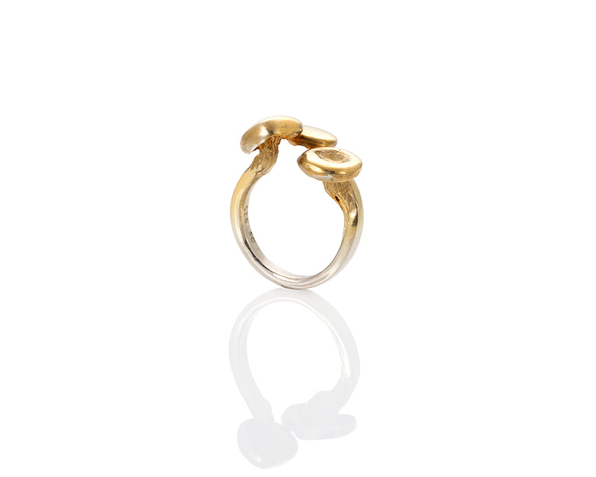 golden oyster mushroom ring. home grown golden oyster mushrooms were grown in logs, cast in silver, molded and then sculpted with a smooth 3mm ring shank. The ring is adjustable with 3 golden oyster mushrooms on top. They come either gold plated, with the gold fading to silver on the shank, or antique finished (oxidized black then repolished,) or in carnation pink silver. The ring is adjustable. This photo is of the gold vermeil version from below, showing the mushroom gills.