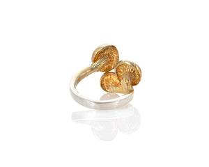 golden oyster mushroom ring. home grown golden oyster mushrooms were grown in logs, cast in silver, molded and then sculpted with a smooth 3mm ring shank. The ring is adjustable with 3 golden oyster mushrooms on top. They come either gold plated, with the gold fading to silver on the shank, or antique finished (oxidized black then repolished,) or in carnation pink silver. The ring is adjustable. This photo is of the gold vermeil version from below, showing the mushroom gills.